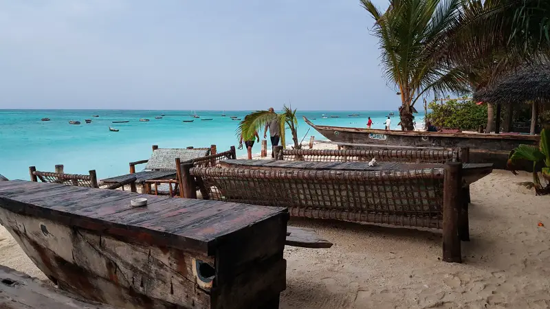 Boats transformed into furniture line the beach at a Nungwi Beach restaurant - Zanzibar